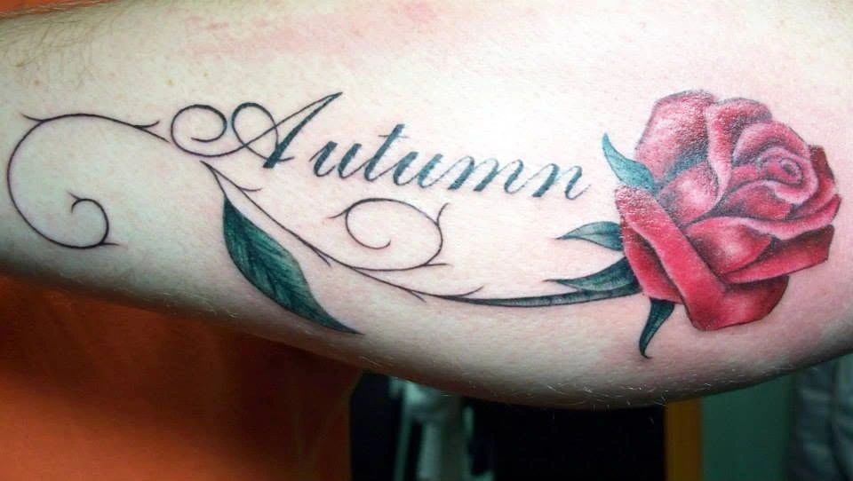 Script lettering and flower tattoo artwork